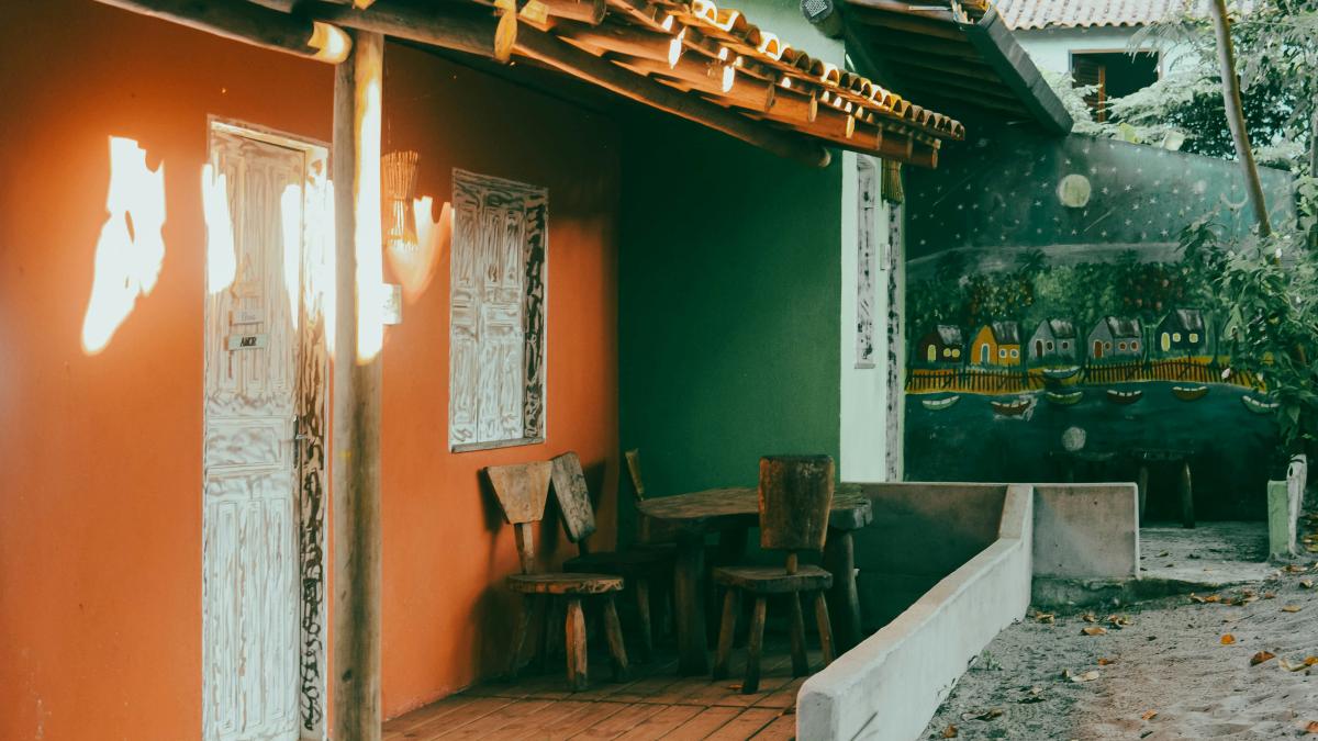 a wooden porch with chairs and a table