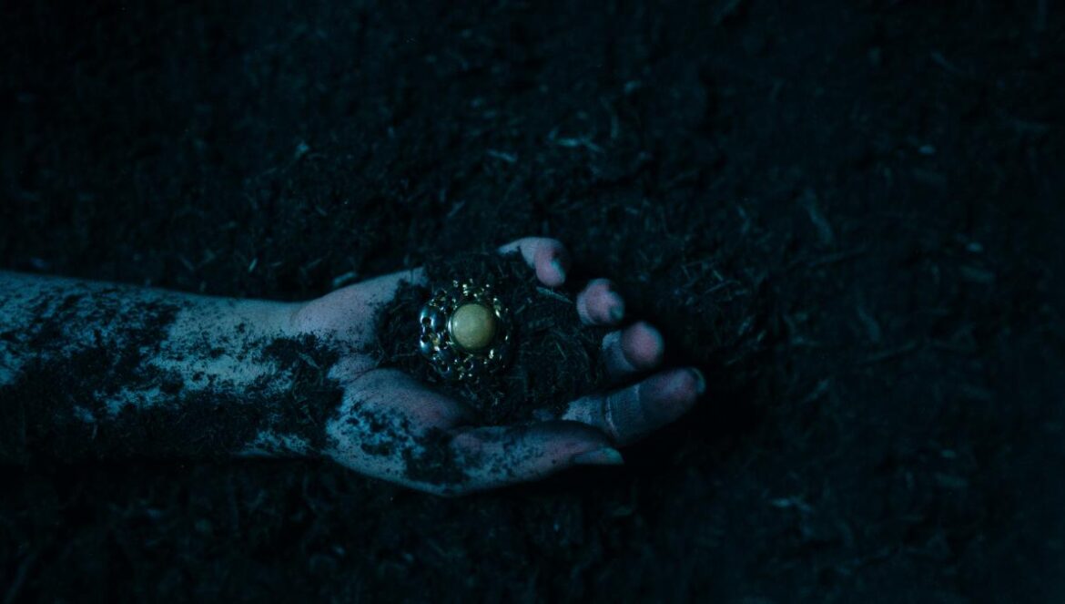 a person's hand holding something in the dark
