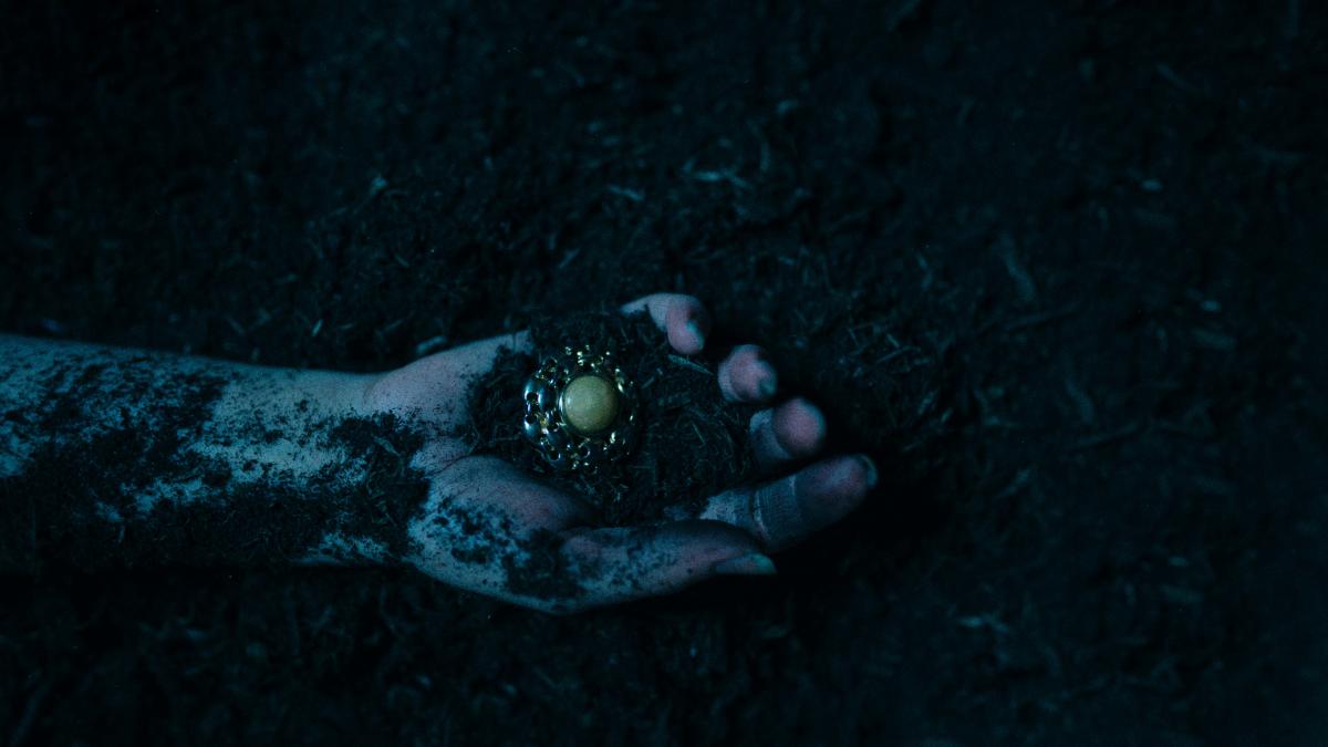 a person's hand holding something in the dark
