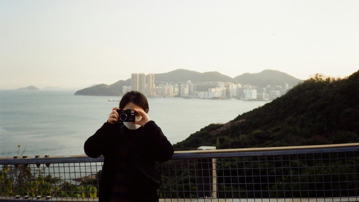 a person taking a picture of a body of water