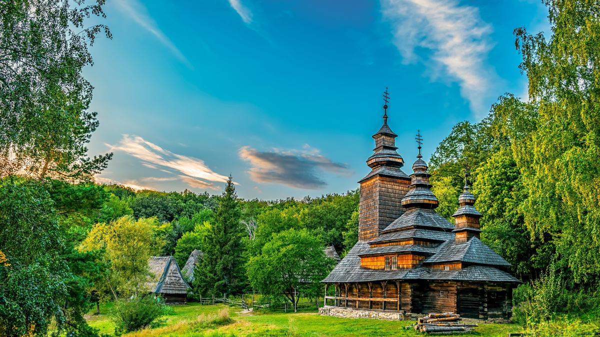 an old wooden church in a forest setting