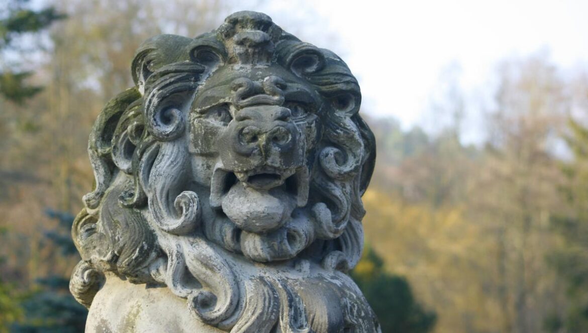 a statue of a lion in a park