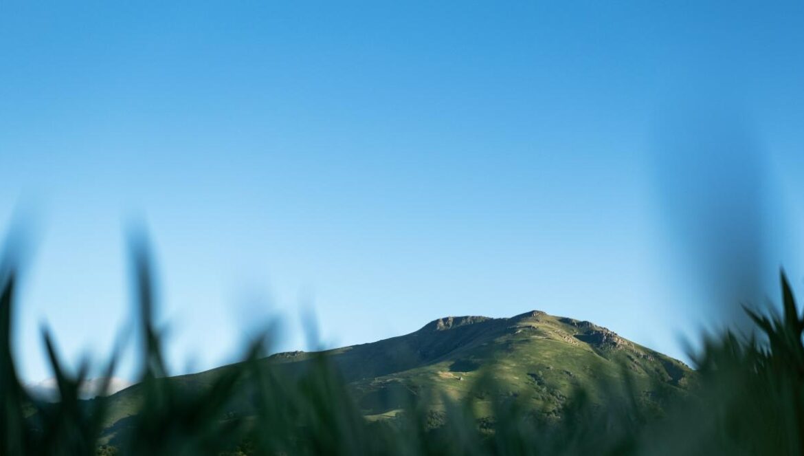 a mountain with a blue sky