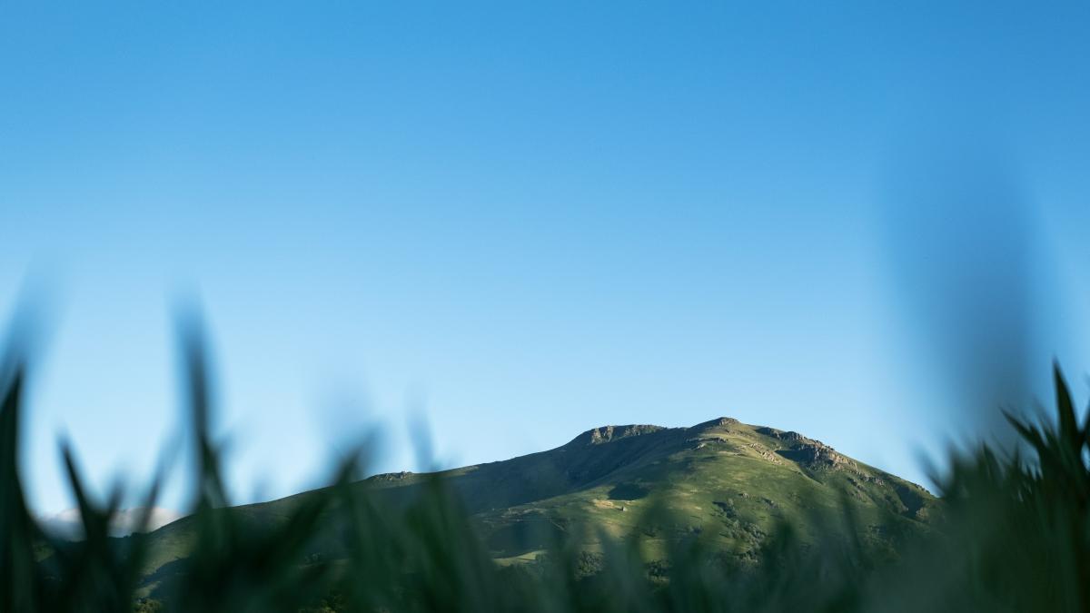 a mountain with a blue sky