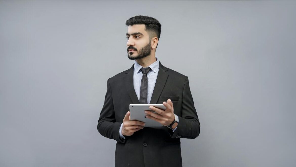 a man holding a tablet