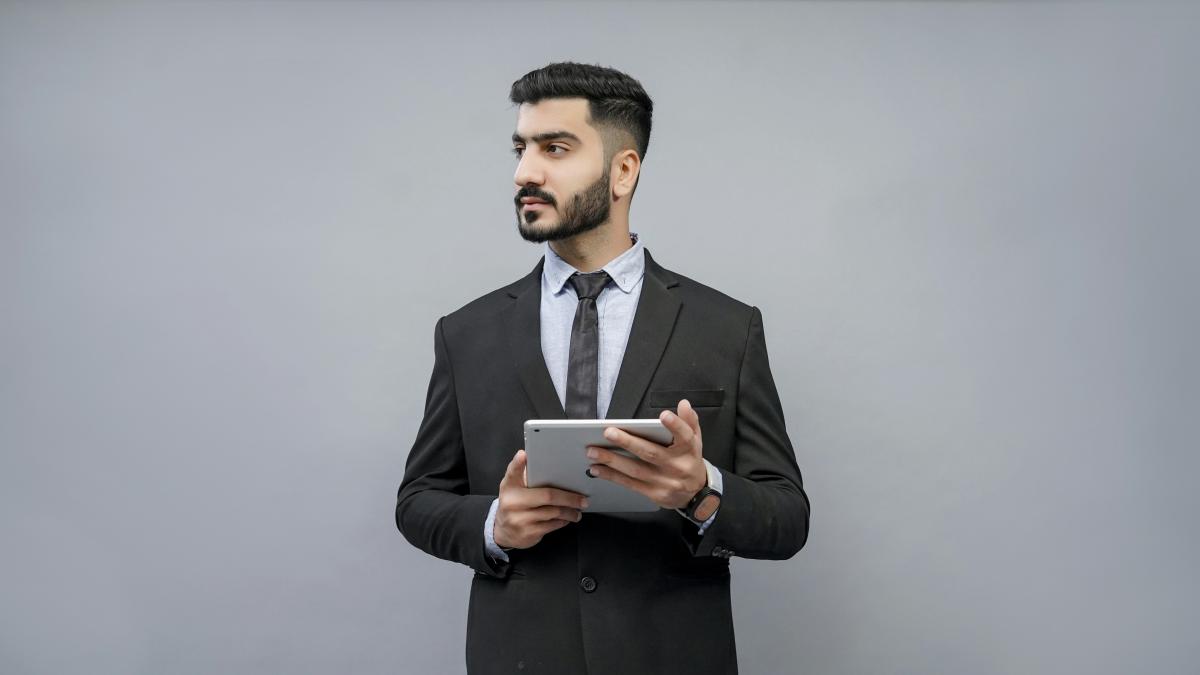 a man holding a tablet