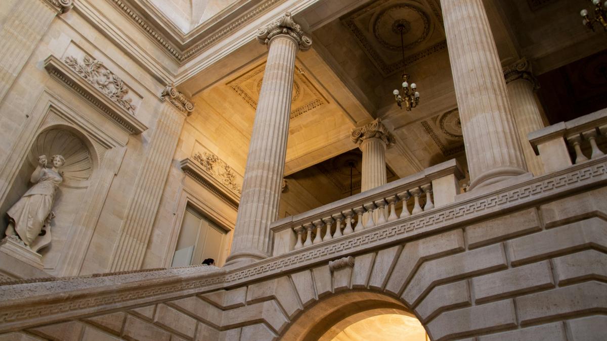 a building with statues and a pillar