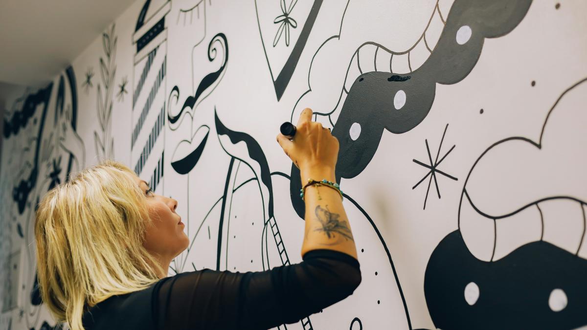 a person drawing on a white board