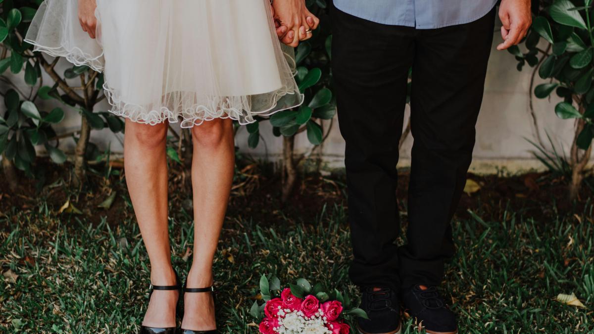 a man and woman holding hands standing next to each other