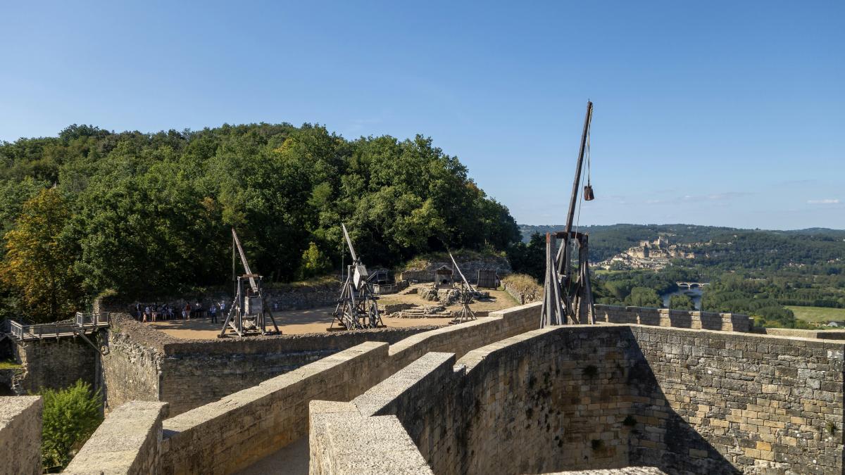 a stone wall with a bunch of metal objects on top of it