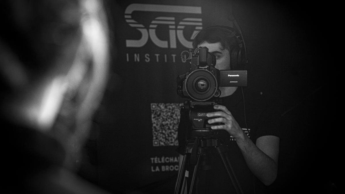 a man holding a camera in front of his face