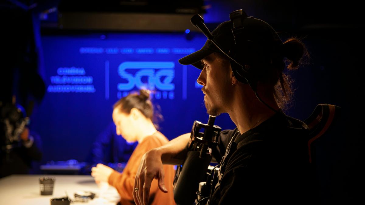 two people sitting at a table in a dark room