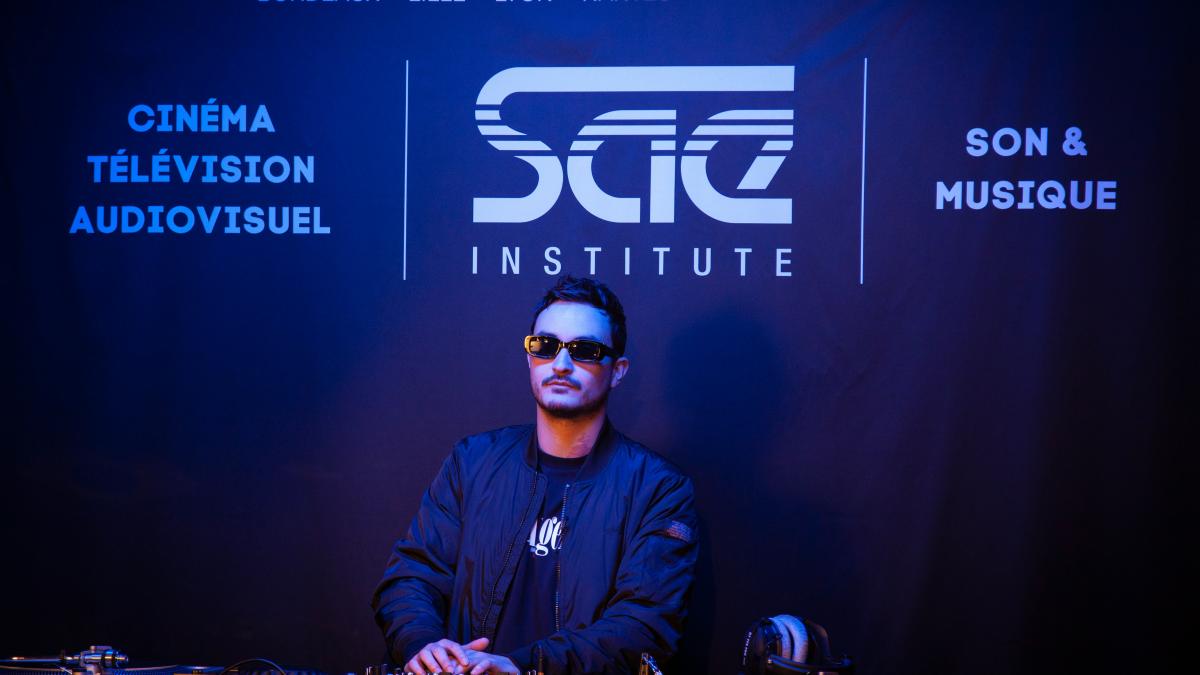 a man sitting at a table in front of a microphone