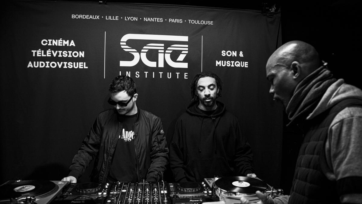 three men in masks are at a dj booth