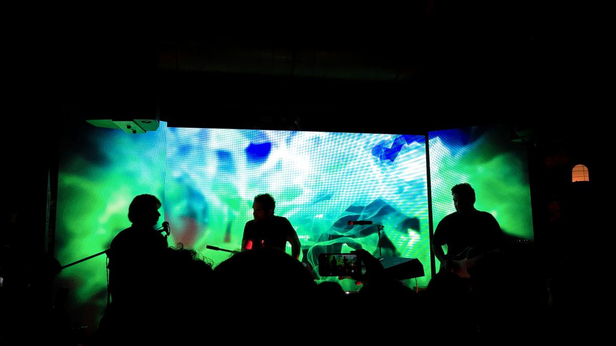 a group of people that are standing in the dark