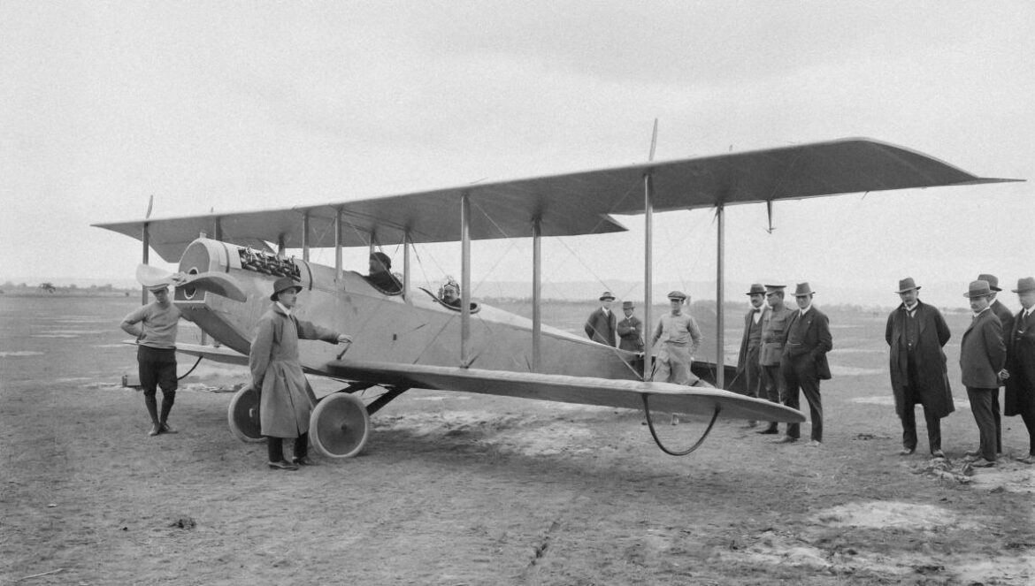 a group of people standing around a small airplane