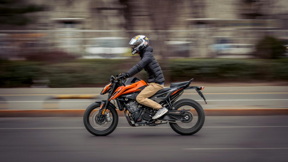 a man riding a motorcycle down a street