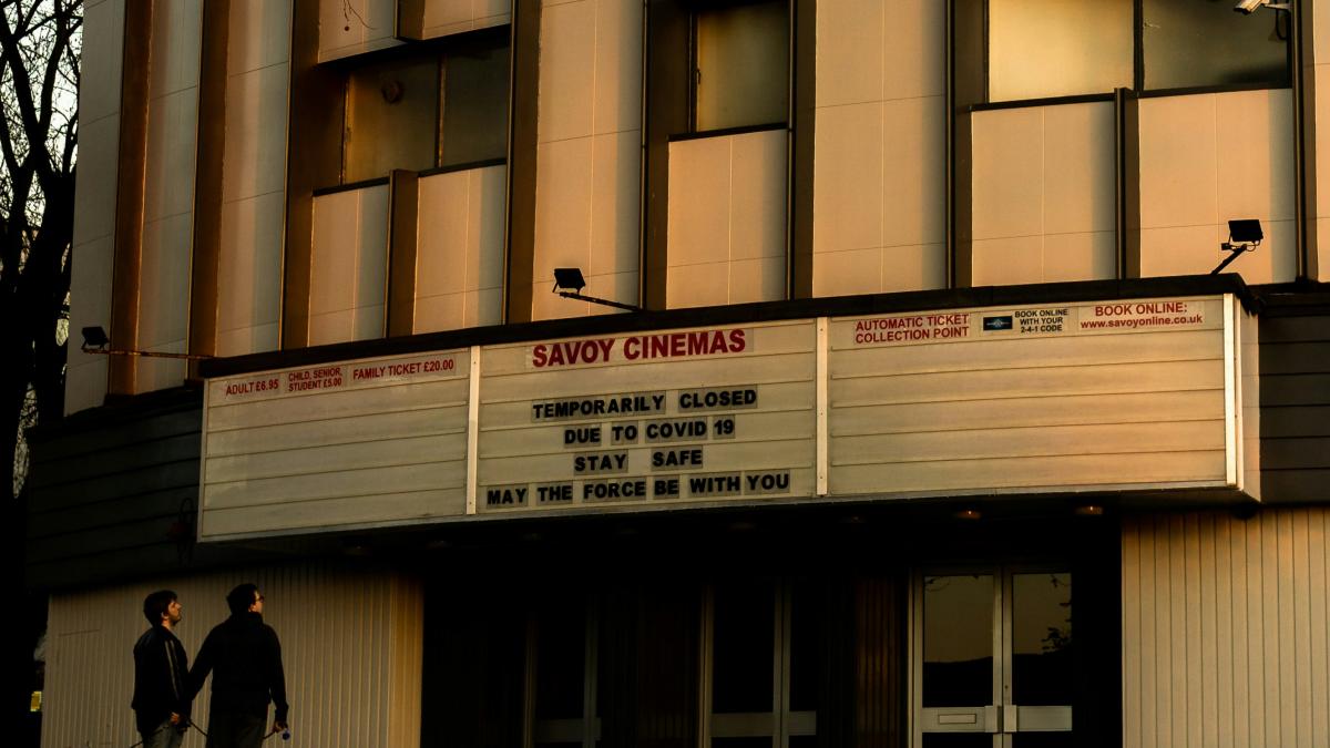 a couple of people that are standing in front of a building