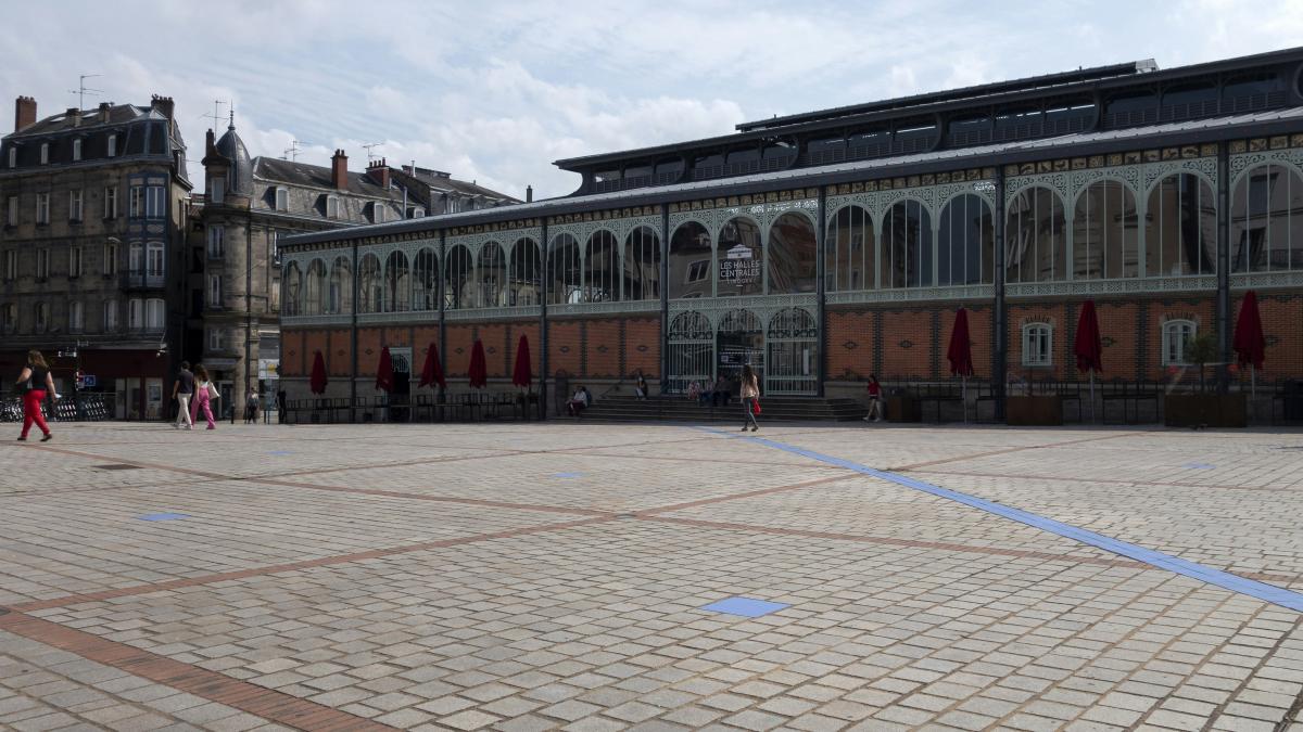 a group of people walking around a large building