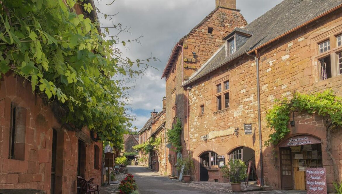 a narrow street with brick buildings and a clock tower