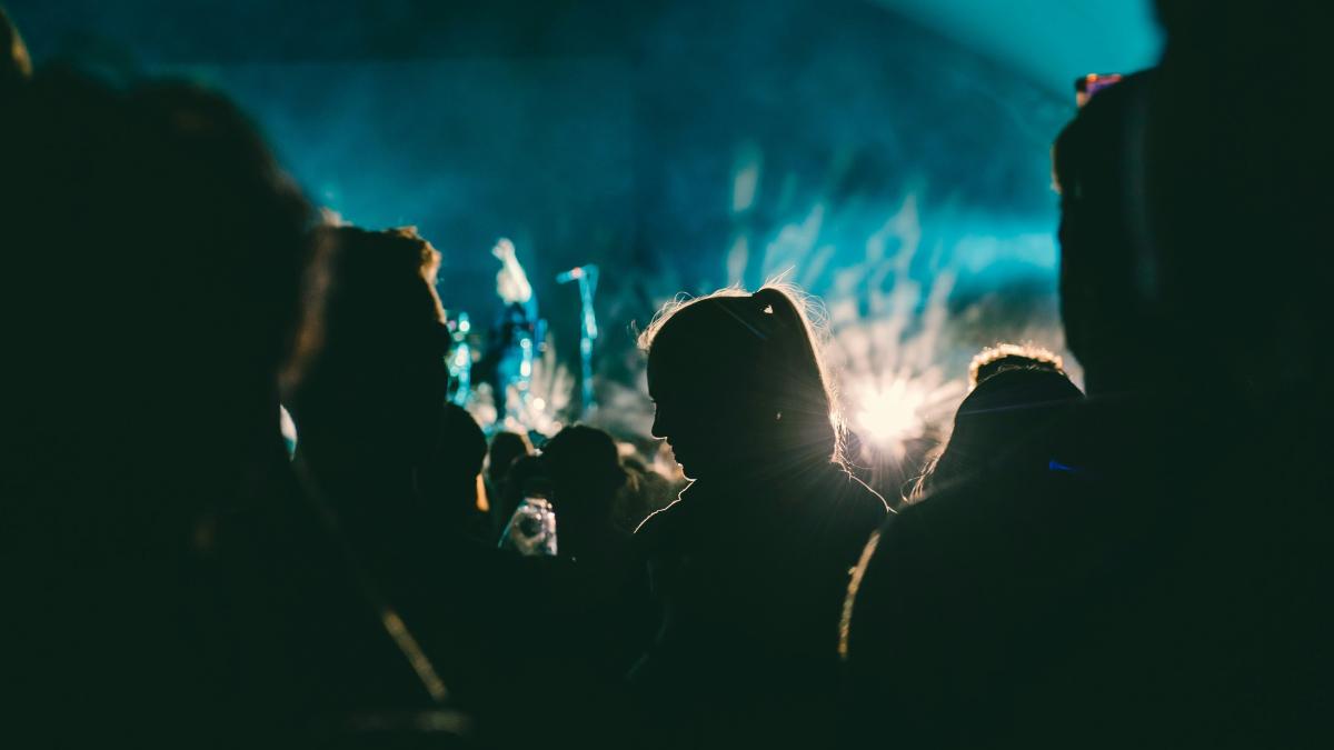 a group of people standing in front of a stage