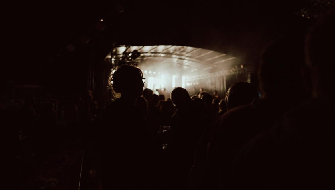 a group of people standing in front of a stage