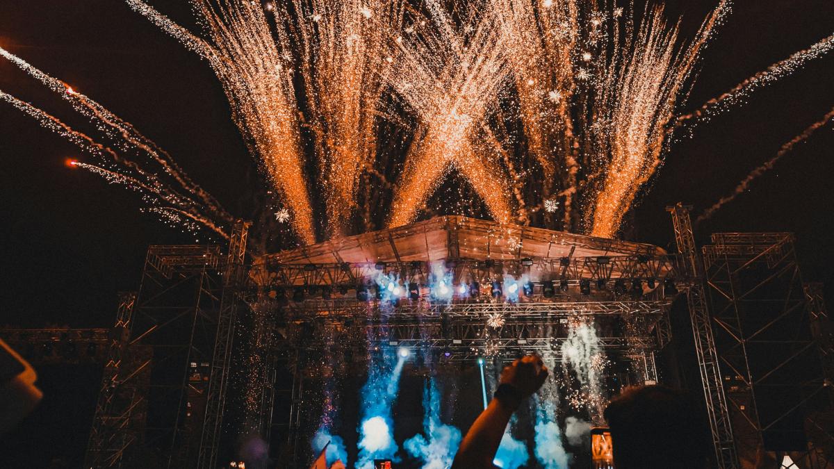 a crowd of people watching fireworks on a stage