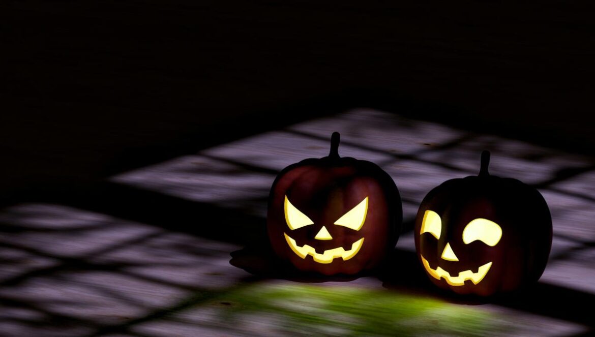 two jack o lantern pumpkins sitting on top of a table