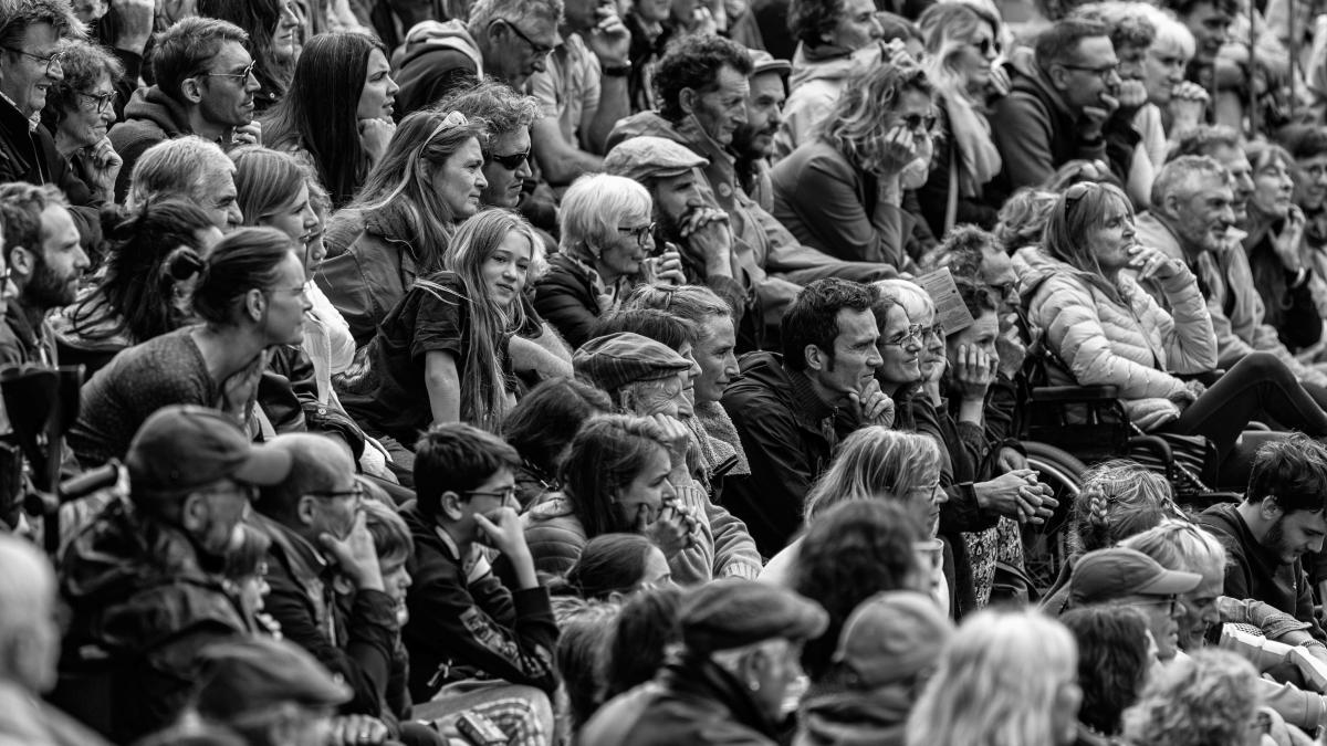 a large group of people sitting next to each other