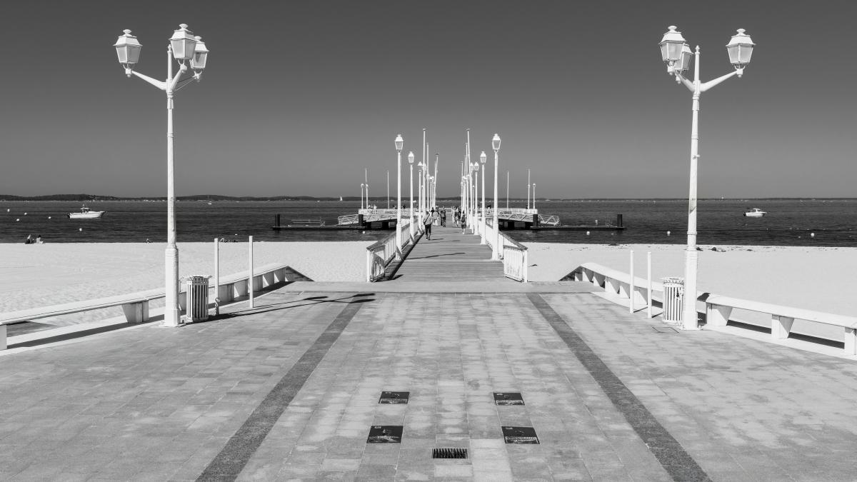 a black and white photo of a pier