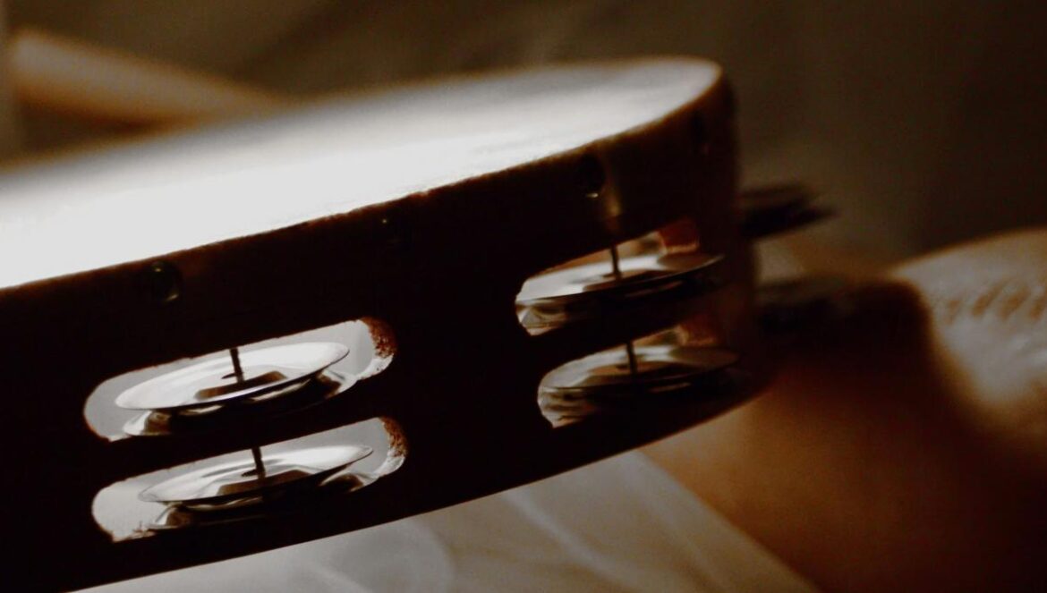 a close up of a person holding a guitar