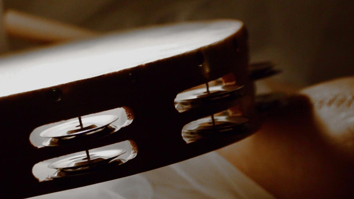 a close up of a person holding a guitar