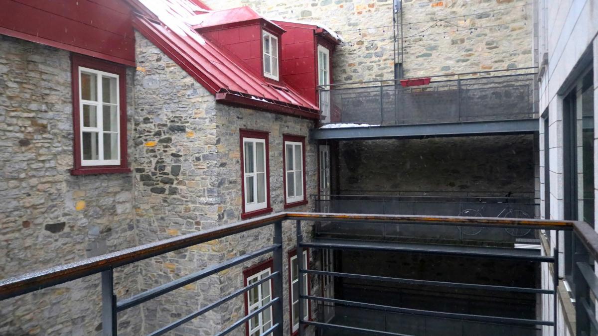 a building with a red roof and a balcony
