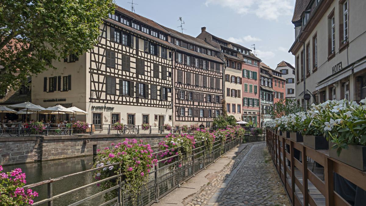 a river running through a city next to tall buildings