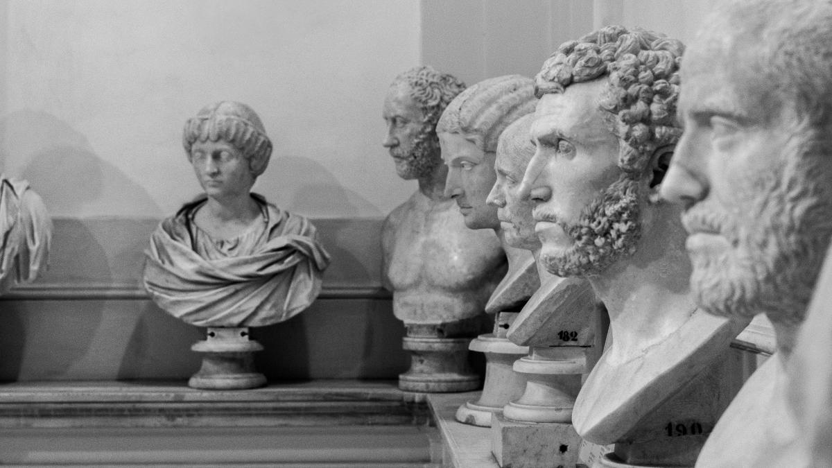 a row of marble busturines in a museum