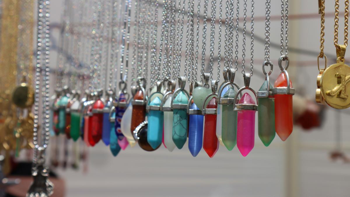 a bunch of necklaces hanging from a rack