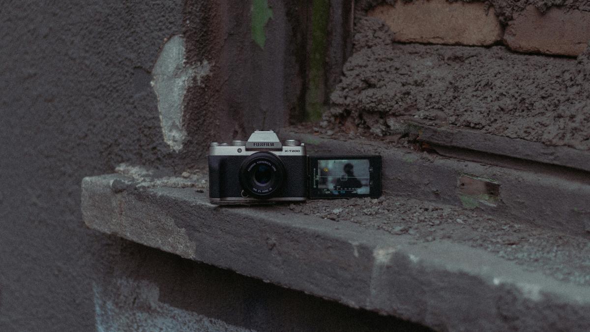 a camera sitting on a ledge in front of a brick wall