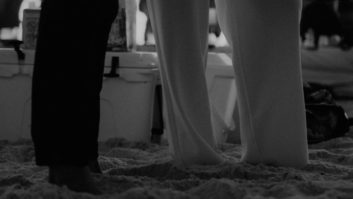 a couple of people that are standing in the sand