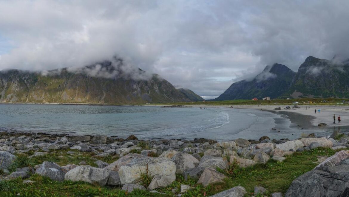 a rocky beach with a mountain in the background