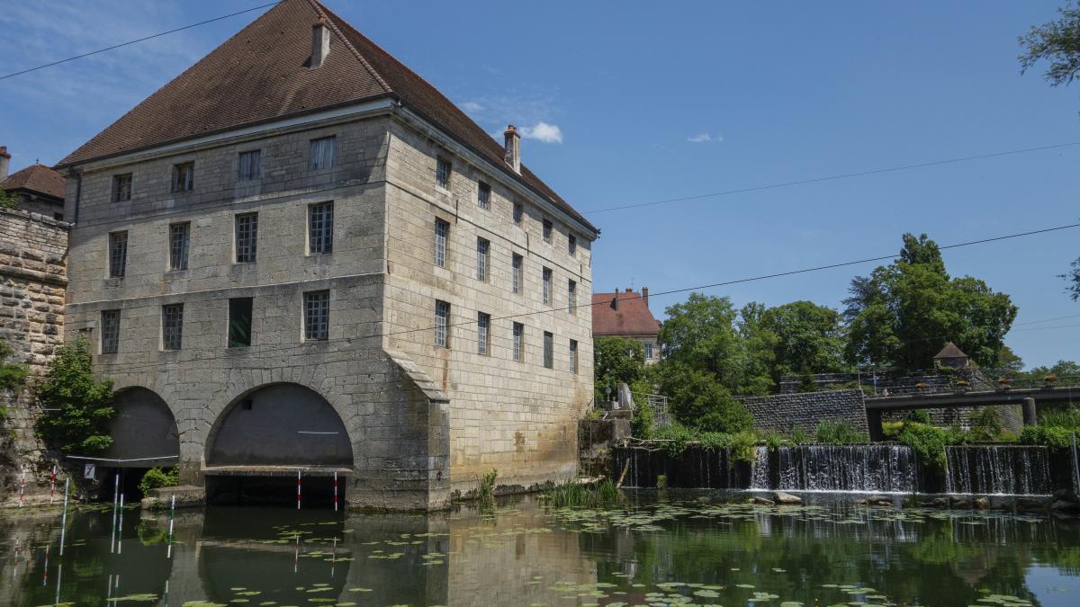 a large building sitting on top of a river