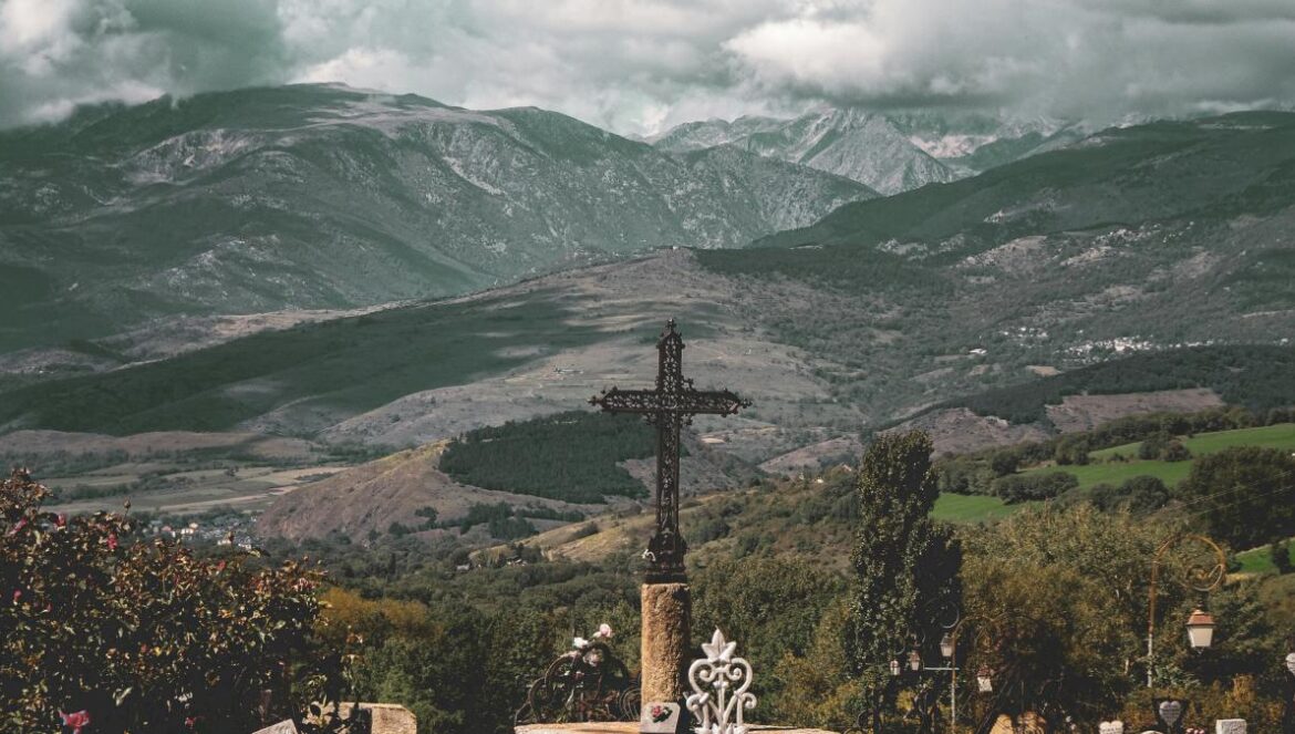 a cemetery with a cross in the middle of it