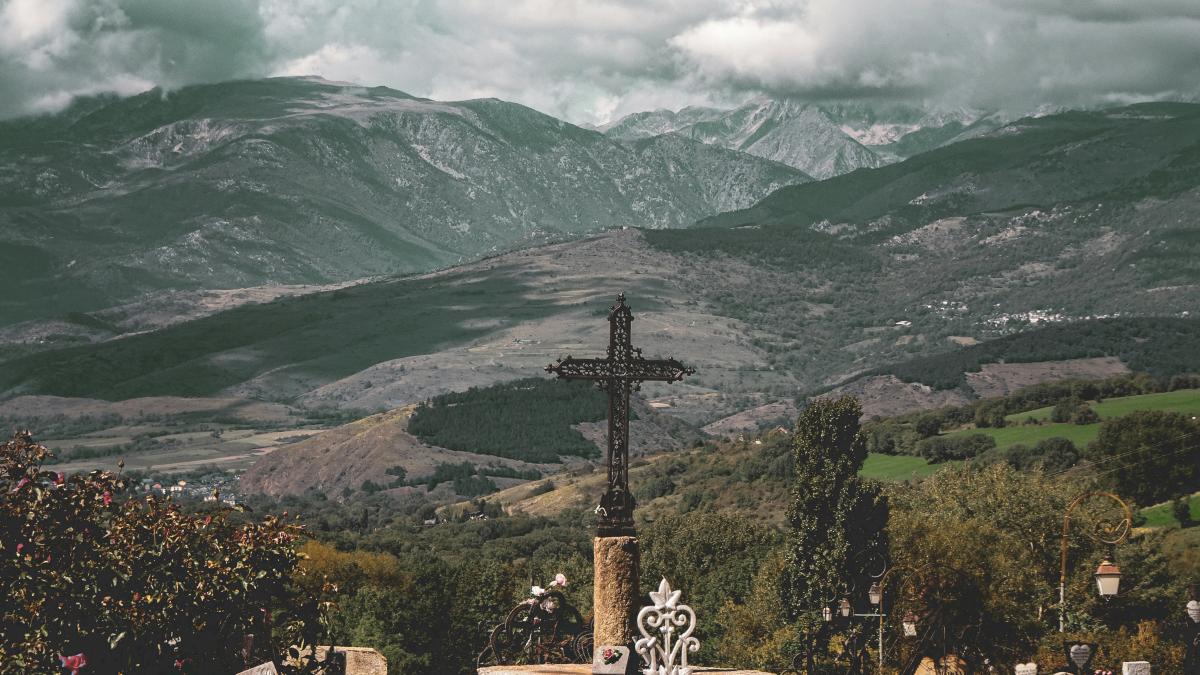 a cemetery with a cross in the middle of it