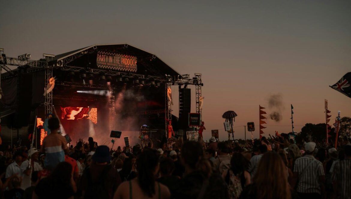 a crowd of people standing around a stage