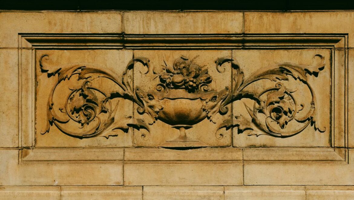 a close up of a decorative object on the side of a building
