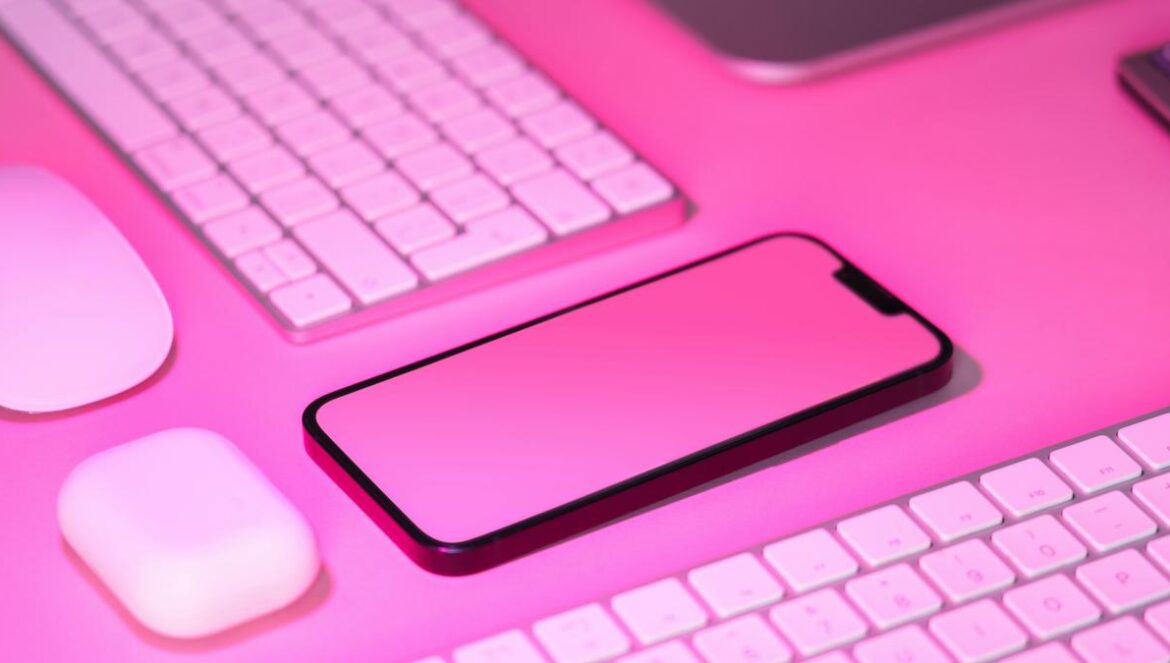 a cell phone sitting on top of a keyboard