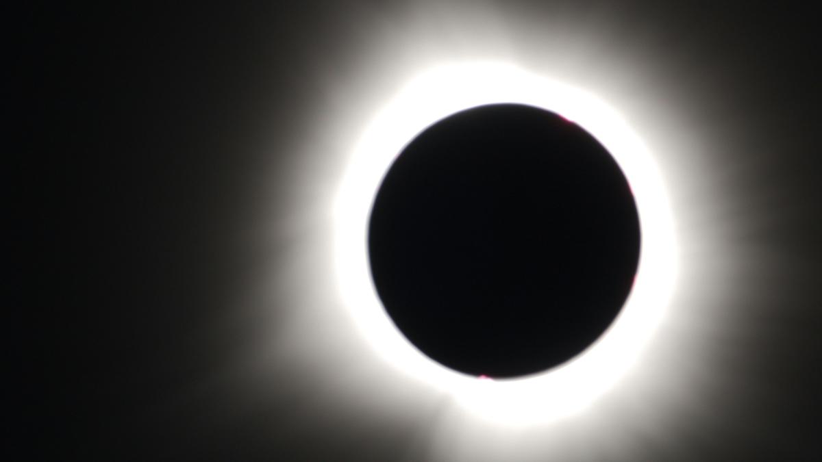 a solar eclipse is seen in the dark sky