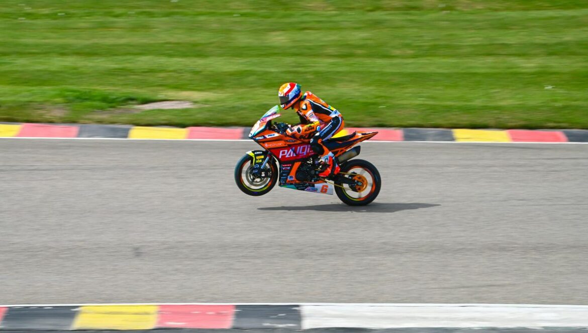 a person riding a motorcycle on a race track