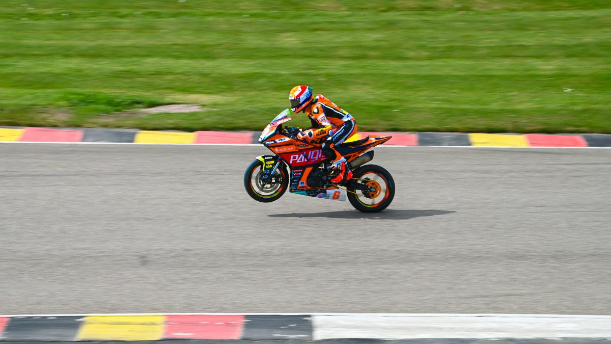 a person riding a motorcycle on a race track