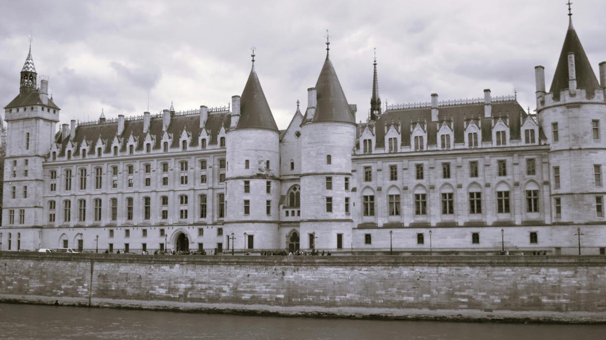 a large castle like building next to a body of water