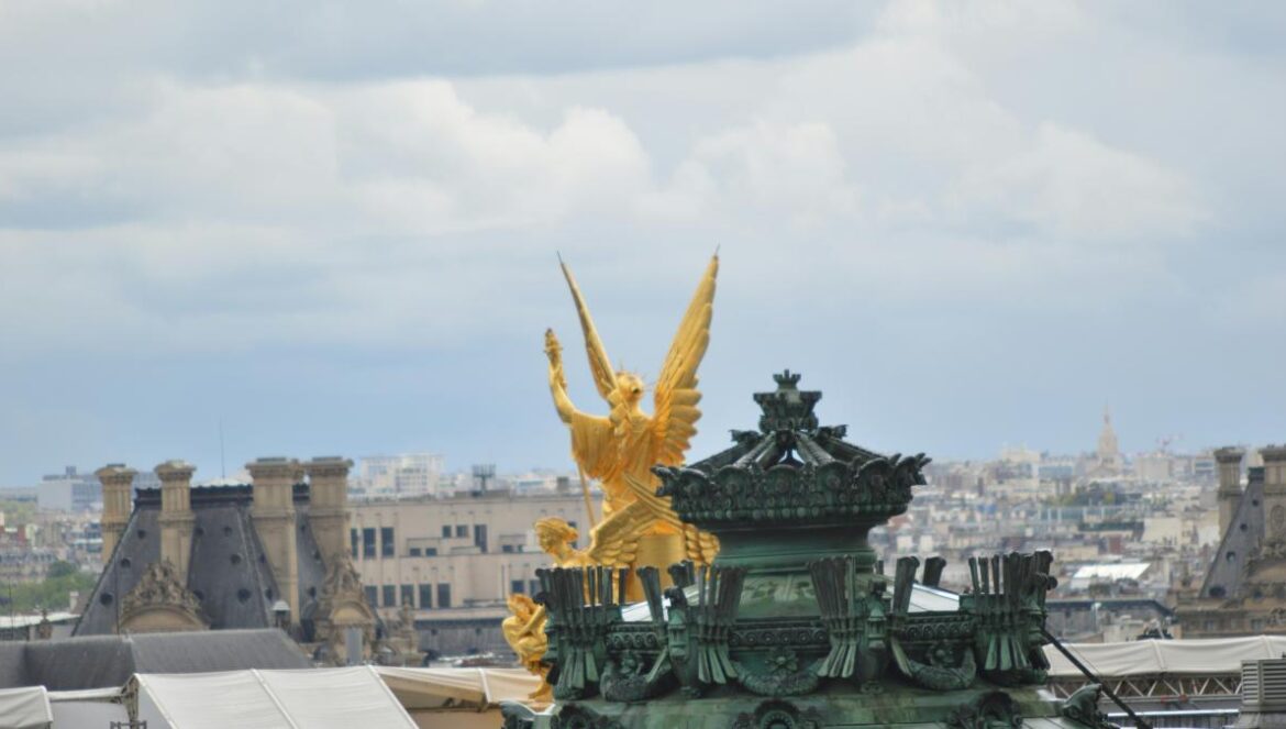 a view of a building with a golden statue on top of it
